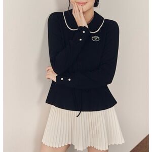 Black Long Sleeve Top with Pearl Details and white pleated skirt